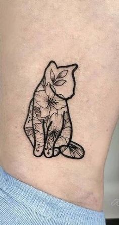 a black and white cat tattoo on the back of a woman's stomach,