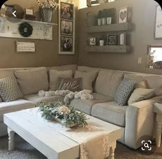 a living room filled with lots of furniture and decor on top of carpeted flooring