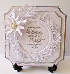 a white card with a snowflake on it's center and saying, wishing you a christmas