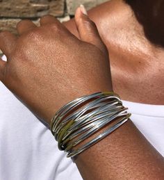 Wrap your wrist with style with this bold & beautiful leather cuff wrap bracelet that features multiple strands of leather cords accented with moveable tube beads that are secured together with a strong magnetic clasp.Every item is handcrafted by me and arrives in a lovely black kraft gift box; ready for gift giving or keeping for yourself!Watch Video: https://www.youtube.com/watch?v=JtI11KpEn2M> Multi Strands of 2mm leather cord> Silver-plated tube accents> Very strong magnetic cla Spring Adjustable Bohemian Cuff Bracelet, Adjustable Wrap Bangle Bracelet, Bohemian Adjustable Cuff Bracelet For Everyday, Adjustable Unique Wrap Bangle Bracelet, Unique Adjustable Wrap Bangle Bracelet, Hand Wrapped Metal Cuff Bracelet, Adjustable Stackable Bangle Wrap Bracelet, Adjustable Stackable Wrap Bangle Bracelet, Nickel-free Adjustable Multi-strand Bracelets