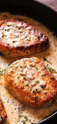 three pieces of meat covered in gravy in a skillet