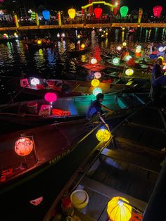 colorful lanterns are floating on the water at night