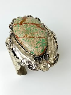 "Vintage Artisan Natural Sea Sediment Jasper Cuff Bracelet - Beautifully made by Navajo artist Percy Spencer - piece is signed - Substantial heavy rigid cuff - Navajo or coin silver, non-magnetic - Huge stone surrounded by very intricate silver work with feathers, flowers, swirls and stamp work on the arm cuff - The jasper stone is natural with lots of green, dark brown matrix and a tan colored background. Almost perfect teardrop shape. - Face of cuff measures 3.5\" x 2.5\" - Width of arm band 2 Artisan Etched Cuff Bracelet, Bohemian Engraved Cuff Bracelet Collectible, Southwestern Style Cuff Bracelet, Bohemian Patina Cuff Bracelet Collectible, Bohemian Style Collectible Cuff Bracelet With Patina, Artisan Hand-tooled Jewelry Bracelet, Handmade Bohemian Cuff Bracelet Collectible, Bohemian Handmade Collectible Cuff Bracelet, Percy Spencer