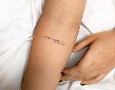 a woman with a tattoo on her arm that reads, i love you to the moon and back