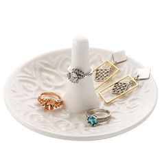 an assortment of rings on a white plate