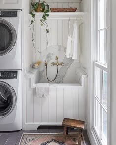 a washer and dryer sitting next to each other in a room with white walls