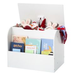 a white book holder filled with books and stuffed animals