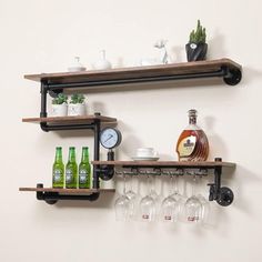 two shelves with wine glasses and bottles on them