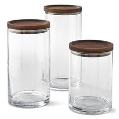 three clear glass jars with wooden lids