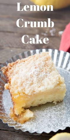 a piece of lemon crumb cake on top of a tin pan with the rest of the cake in the background