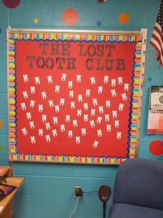 a room with a sign that says the lost tooth club on it and some chairs in front of it