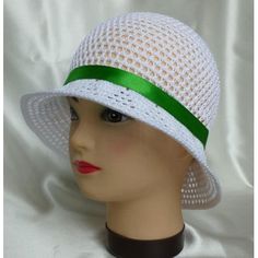 a mannequin head wearing a white and black hat