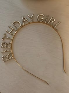 a gold headband with the word bride spelled out in crystal beads on top of it