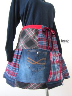 a woman's skirt made out of old jeans and plaid fabric is displayed on a mannequin