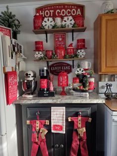 a kitchen decorated for christmas with candy canes and stockings hanging on the stove top