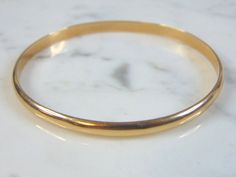 "FOR SALE IS A WOMEN'S VINTAGE ESTATE 17K YELLOW GOLD BRACELET. THE INSIDE CIRCUMFERENCE OF THE BRACELET MEASURES ABOUT 7 3/8\" AND ABOUT 1/8\" WIDE. BRACELET WEIGHS 6.7g. THIS WOULD MAKE A LOVELY GIFT AND IS A GREAT VALUE FOR THE MONEY. IF ANY OTHER QUESTIONS, PLEASE ASK. BE SURE TO CHECK OUT SOME OF MY OTHER GREAT ITEMS UP FOR SALE. THANK YOU IF THERE ARE ANY ISSUES PLEASE CONTACT US, WE'RE ALWAYS HAPPY TO TRY TO HELP YOU OUT AS BEST AS WE CAN." Formal Gold Bracelet With Polished Finish, Formal Polished Gold Bracelet, Antique Yellow Gold Bangle For Formal Occasions, Formal Yellow Gold Round Bangle, Hallmarked Gold Bangle Bracelet For Formal Occasions, Heirloom Gold Bracelet Stamped 14k, Round Yellow Gold Bracelet Stamped 14k, Timeless Gold Diamond Bracelet, 14k Stamped Yellow Gold Round Bracelet