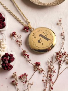 an antique pocket watch sits on a table surrounded by dried flowers and other decorative items