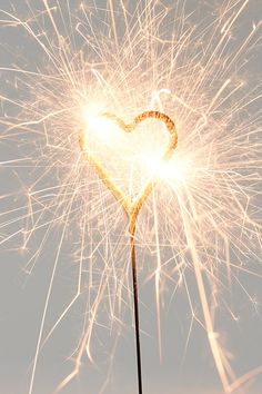 a heart shaped sparkler on top of a stick