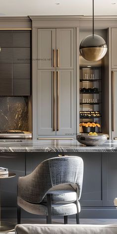 an elegant kitchen with gray cabinets and marble counter tops is pictured in this image from the front view