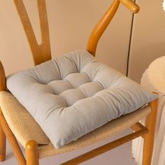 a wooden chair with a cushion on it