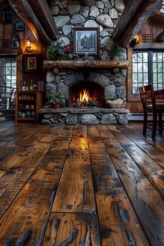 a living room filled with furniture and a fire place in the middle of a wooden floor