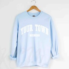 Customize your city and state on this comfy sweatshirt! The collegiate text can also be personalized to display your university crewneck sweater. FREE SHIPPING All items are made to order and there are no returns on merchandise. Please be sure to double check your order before placement, and see sizing chart and size recommendations to find the best fit for you! Ideal for any situation, this UNISEX heavy blend crewneck sweatshirt is pure comfort. These garments are made from polyester and cotton University Logo Sweatshirt For College, University Logo Sweatshirt For Campus, Collegiate Style Relaxed Fit Top For Campus, Collegiate Relaxed Fit Tops For Campus, Collegiate Crew Neck Top For Campus, Collegiate Relaxed Fit Sweatshirt With Text Print, Collegiate Text Print Relaxed Fit Sweatshirt, University Logo Sweatshirt For School Spirit, College Sweatshirt With Lettering Fan Apparel