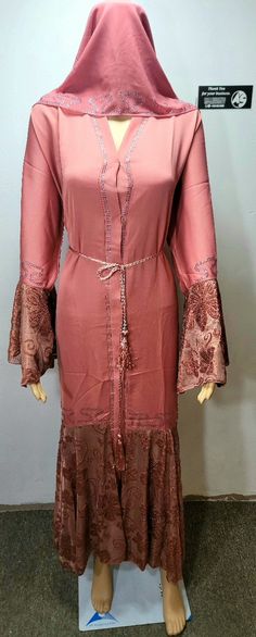 Original Dubai abaya, directly shipped from Dubai. Material of this abaya is Nidah. Pink color with embroidered lace & rhinestones down the front and back.  An exquisite abaya adorned with rhinestones is a true work of art. The abaya is crafted from high-quality, flowing fabric that drapes elegantly over the wearer's body, adding a touch of luxury and sophistication to any occasion. CHEST SIZES ARE PROVIDED IN INCH IN THE DROP-DOWN BAR. For example, size 54 (Chest 44-45) means Abaya length is 54 inches and chest is 44 to 45 inches. expect 1   inch + or - due to stitching reason.  We believe in providing Real Pictures and videos of the products. With Real Pictures, you can trust that what you see is what you get. Say goodbye to stock photos and hello to authentic product visuals that truly Modest Long Abaya For Eid, Bohemian Long Abaya With Dabka, Bohemian Maxi Length Abaya For Eid, Bohemian Floor-length Abaya With Dabka, Bohemian Floor-length Dabka Abaya, Bohemian Long Sleeve Abaya With Dabka, Long Modest Abaya With Dabka, Modest Long Abaya For Festive Occasions, Bohemian Floor-length Abaya For Eid