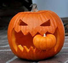 a carved pumpkin sitting on top of a brick floor