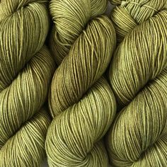 several skeins of green yarn sitting on top of each other