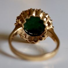 This Tudor design features 0.83 carats of diamonds encircling a malachite cabochon. Available in sizes 5-8. Formal Oval Malachite Jewelry, Elegant Malachite Gemstone Ring, Elegant Green Malachite Rings, Formal Malachite Gemstone Rings, Formal Green 14k Stamped Cluster Ring, Formal Green Cluster Ring Stamped 14k, Green 14k Stamped Cluster Ring For Formal Occasions, Tudor Design, Catherine Parr