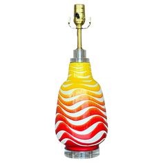 a yellow and red lamp with a white background