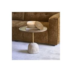 a table that has two plates on it and one is sitting on the floor in front of a couch