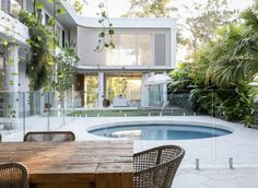 a wooden table sitting next to a swimming pool