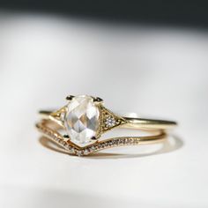 a white diamond ring sitting on top of a table