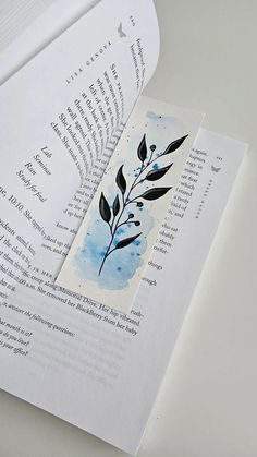 an open book with watercolor leaves on it