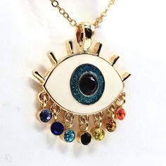 Add Some Bohemian Charm To Your Jewelry Collection With This Beautiful Eye-Catching Pendant Necklace From Harleyscrazedcreations. The Necklace Features A Colorful Evil Eye Ball With Rainbow Tear Drop Lashes, Adding A Touch Of Art And Beauty To Your Outfit. The Pendant Is Made Of Enamel And Glass, Iron, And Zinc Alloy. The Lobster Closure And Adjustable Features Ensure That The Necklace Fits Comfortably Around Your Neck. With Seven Gemstones And A Glass Main Stone, This Necklace Is Perfect For Th Multicolor Metal Pendant Charm Necklaces, Handmade Multicolor Charm Necklaces For Parties, Multicolor Metal Charm Necklace With Adjustable Chain, Multicolor Dangle Charm Necklaces Gift, Multicolor Pendant Charm Necklace As Gift, Colorful Metal Necklace As A Gift, Colorful Metal Necklaces For Gifts, Colorful Metal Necklaces As Gift, Multicolor Evil Eye Necklace For Gift