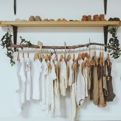 several pairs of shoes are hanging on a rack with clothes and linens in them