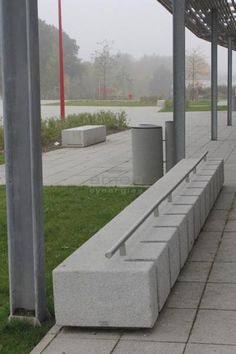 a concrete bench sitting on top of a sidewalk