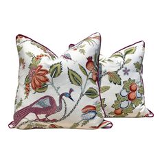 two pillows with birds and flowers on them, one is white and the other is red