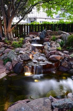 a small waterfall in the middle of a garden