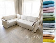 a white couch sitting on top of a wooden floor next to a pile of towels