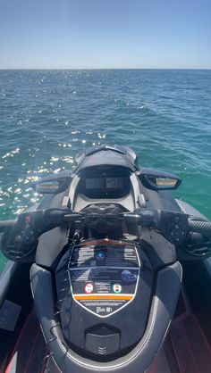 the front end of a boat in the water with an electronic display on it's console