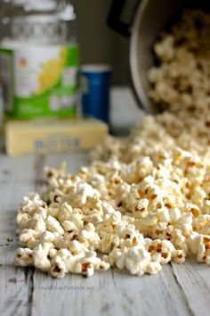 popcorn spilled out of a bucket onto a wooden table