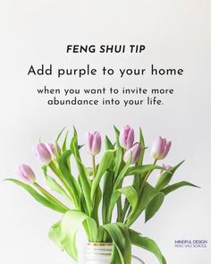 a vase filled with pink tulips sitting on top of a table