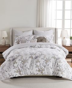 the comforter is white and has flowers on it