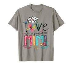 a gray t - shirt with the words love and flowers on it, in multicolored letters