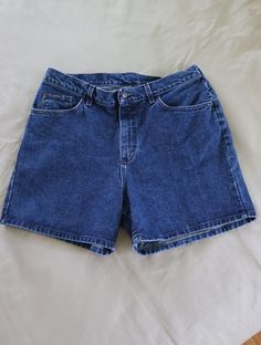 High-waisted / high-rise jean shorts by Lee Riders from the 1980s or 1990s.  100% Cotton and SO much more flattering than low-cut stretchy jeans!!  Button and zipper closure.  Size tag is unreadable - 18" waist measured flat (36 inches total); hips measure 23 inches flat (46 inches total); 12" from waist to crotch seam in front; 17" from waist to crotch seam in back; 5" inseam. Clean (freshly laundered and line dried), no stains, no holes. Measured flat, so the actual fit may vary somewhat. Measure a similar garment that fits you in the same manner for comparison. Visit my shop for more vintage clothing, fabric, fabric panels, quilt blocks and quilt tops, vintage patterns, needlework and kits, original handmade creations and more - https://www.etsy.com/shop/VirgieMae Lee24 Low Waist Jeans, Clothing Fabric, Shorts Outfits, High Rise Denim Shorts, Stretchy Jeans, Retro Summer, Blue Jean Shorts, Jeans Button, High Rise Denim