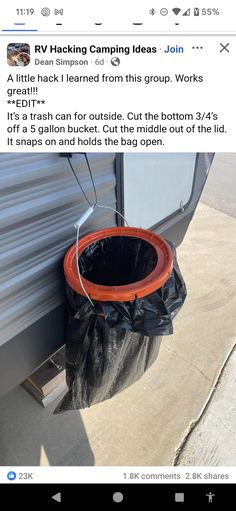 an orange and black trash can sitting next to a white trailer