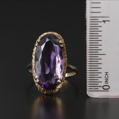 Style: Victorian Materials: 9K Gold Ring Size: 6.75 Hallmarks: 9 with Pictorial Markings Total Weight: 2.10 dwt Primary Stone Type: Amethyst Primary Stone Shape: Oval Faceted Primary Stone Count: 1 Primary Stone Dimensions: 20.00 mm x 10.00 mm Formal Gold Amethyst Ring With Diamond Cut, Classic 14k Gold Amethyst Ring For Formal Occasions, Classic Formal Amethyst Ring, Classic Hallmarked Amethyst Ring For Formal Occasions, Classic Formal Hallmarked Amethyst Ring, Formal 14k Gold Hallmarked Amethyst Ring, Hallmarked Yellow Gold Amethyst Ring For Formal Events, Classic Yellow Gold Amethyst Ring With Diamond Cut, Formal Hallmarked Yellow Gold Amethyst Ring