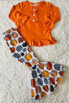 Top features solid orange body color w/ruffles & long sleeve cut. Bottoms feature multi shapes pumpkin prints on white background & flare legs. Soft, breathable, stretchy, and comfortable fabric. Perfect set for a western look. Material: Polyester & Spandex. Includes: Top & Bottoms. Printed Cotton Sets For Fall, Fitted Cotton Set For Fall, Fitted Ruffle Sets For Fall, Cute White Sets For Fall, Playful Fitted Tops For Fall, Fitted Matching Sets For Fall, Long Sleeve Ruffled Sets For Fall, Orange Long Sleeve Halloween Sets, Cute Printed Fitted Sets